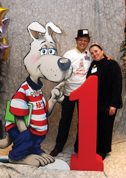 Jay Deshpande, M.D., and Rosie Boyd pose with a Champ cutout during the Monroe Carell Jr. Children's Hospital at Vanderbilt's first birthday party. 
photo by Dana Johnson
