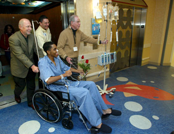 The first in-patient moved from the sixth floor of Vanderbilt University Hospital, Gary Ellis, arrives on the eighth floor of Vanderbilt Children's Hospital, accompanied by Dr. Harry Jacobson, vice chancellor for Health Affairs, Jim Shmerling, Vanderbilt Children's Hospital CEO and hospital namesake Monroe Carell Jr. Photo by Neil Brake