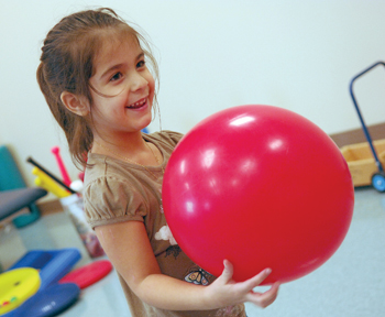 Patient Anna Harkovich-Abdullah, 4, plays in the Orthopaedic Gym. (photo by Dana Johnson)