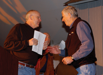 Ray DuBois, M.D., left, makes a presentation to Moses.
photo by Dana Johnson