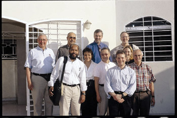 AIDS researchers pose in front of the GHESKIO center in Port-au-Prince, Haiti. 
Back row, left to right: Drs. Warren Johnson Jr., chief of the Division of International Medicine and Infectious Diseases at the Weill Cornell Medical College; Jean Pape; Barney Graham; and David Haas. Front row, left to right: Drs. Greg Wilson, assistant professor of Pediatrics, Vanderbilt; Marie Marcelle Deschamps, GHESKIO; John Ho, Cornell; Spyros Kalams, associate professor of Medicine, Vanderbilt; Becca Dillingham, University of Virginia; and Peter Wright. Photo by Jonathan Rodgers