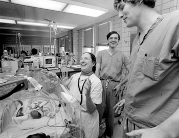 Stahlman shares a laugh with residents during rounds in the NICU, back when it was housed in Medical Center North.