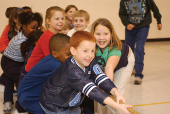 Front to back, Justin Northcutt, Wilson Phillips, Cayci Heist, and other classmates, all third-grade students at Stratton Elementary School, do a strengthening exercise game of tug-of-war in P. E. class as part of the Healthy Heart Project. 