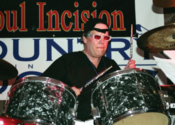 "Bad Boy," the alter-ego of transplant surgeon Dr. C. Wright Pinson, plays drums during Soul Incision's rocking performance. The band was such a hit, it's on the bill already for Country in the Rockies X, Jan. 27-Feb. 1, 2004.