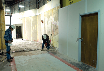 Crews work to transform the former retail space into outpatient clinics. (photo by Neil Brake)