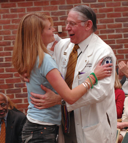Kate Cleaver gets a hug from VUSM Dean Steven Gabbe, M.D. (photo by Dana Johnson)