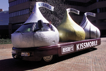 Resembling three giant Hershey’s Kisses chocolates, the Kissmobile has the capacity to store 230,000 pieces of candy in a refrigerated compartment.  It also has a built-in blower to disseminate a smell of chocolate around the vehicle. (photo by Dana Johnson)