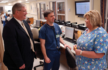 Brent Lemonds, M.S., administrative director of Emergency Services, John Paul Rohde, M.D., and Elizabeth Reeves, R.N., a charge nurse in the Emergency Department, discuss strategies to recognize employees who adopt elevate credo behaviors.
Photo by Dana Johnson
