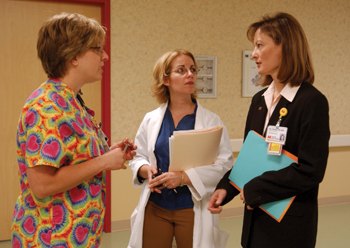 Chenger talks to nurses Kristen Denmon, left, and Lorraine Patterson in the PCCU. Nurse wellness is one of Chenger’s priorities. Photo by Dana Johnson