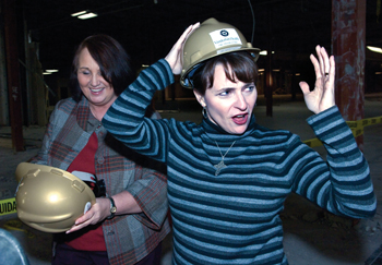 The Breast Center’s Pamela Jeanneret, right, and Diane Harris adjust their hard hats at the event. (photo by Neil Brake)