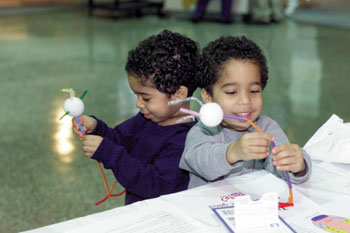 Twins Darran and Jeremy Medley build models of a neuron, one of the hands-on activities at the event. (photo by Dana Johnson)