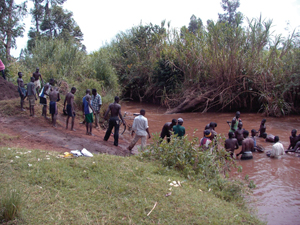 A team of villagers dredges sand from a nearby river to make the clinic foundation.