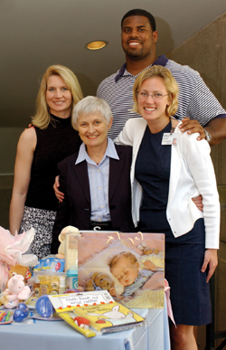 Kim and Fred Miller, back, pose with Dr. Pat Temple and third-year medical student Elise Cornet at the Nurses for Newborns baby shower this week.