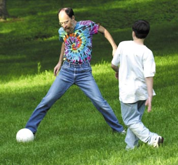 Finder always finds time to play backyard soccer with his children after working at the hospital. (photo by Neil Brake) 