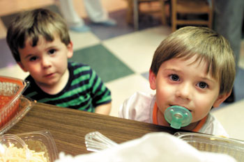 Brothers Zachary and Noah Harris waited their turn in line to get dinner at this week's Family Soup Night, provided by Friends of Children's Hospital. The brothers had a sibling in the hospital. (photo by Dana Johnson)