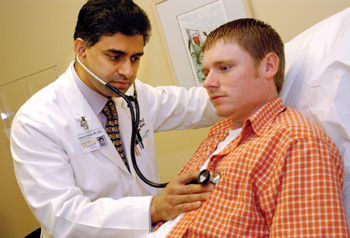 Terry Plunkett is examined by Dr. Dawood Darbar in the genetic arrhythmia clinic. (photo by Dana Johnson)
