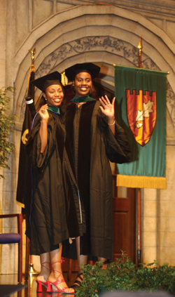 Constance Mobley, right, and her sister Dr. Norma Denise Mobley wave to their parents after Norma gave Constance her diploma. (photos by Dana Johnson)