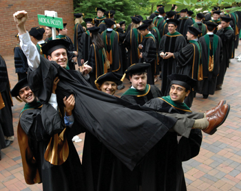 VUSM student Josh Nepute gets a lift from classmates while lining up for commencement. (photo by Neil Brake)