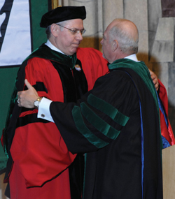 Steven Gabbe, M.D., left, presiding over his final graduation as VUSM dean, embraces Harry Jacobson, M.D. (photo by Neil Brake)