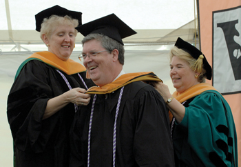 Keith McKernan is hooded by Bonnie Pilon, D.S.N., R.N., left, and Linda Norman, Ph.D., M.S.N., at the VUSN investiture ceremony. (photo by Dana Johnson)