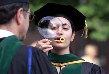 Celebrate! Yasmine Ali blows a bubble before graduation begins. (photo by Dana Johnson)