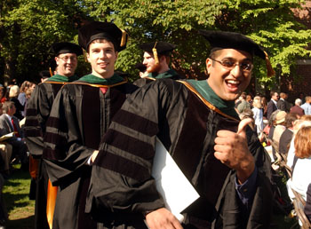 Brian Kamdar gives a thumbs up during the School of Medicine processional at graduation.
Photo by Dana Johnson
