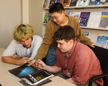 From left, Dan Ruley, Chuan Liang, and Drew Sheldon, all sophomores at MLK, look at science publications during their visit to Vanderbilt.