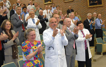 The crowd of faculty and staff members gives Dean Steven Gabbe, M.D., a standing ovation after his remarks. (photo by Neil Brake)