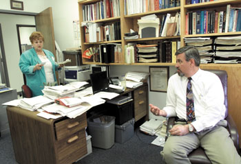 Dr. Barney Graham meets with his assistant Joyce Keltner.  Graham has worked at Vanderbilt for 22 years. (photo by Dana Johnson)