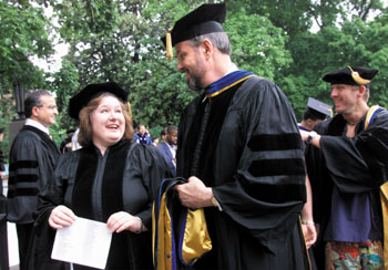 Teresa Johnson, who received her Ph.D. in Microbiology and Immunology, chatted with her mentor Dr. Barney Graham prior to the Graduate School's ceremony in May 2000. Johnson will go with Graham to the NIH as a staff scientist. (photo by Dana Johnson)