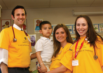 Vanderbilt medical students volunteering their time to assist in diabetes outreach efforts include, from left, Bill Heerman, Miranda Raines (holding Kevin Juarez) and Veronica Slootsky. (photo by Mary Donaldson)
