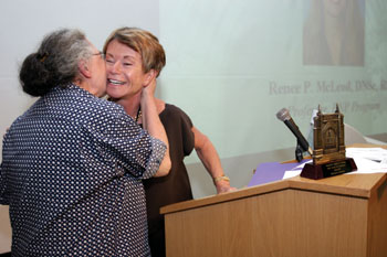 Phronietta Kendrick, Office Assistant for the MSN Department at VUSN, kisses Dean Colleen Conway-Welch, Ph.D., after receiving the School Life Staff Award.  
photo by Kats Barry