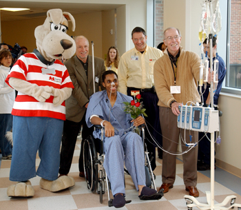 Carell, right, helps during the transfer of patients to the newly opened Children’s Hospital in 2004. Also accompanying first patient Gary Ellis are, from left, Champ, Harry Jacobson, M.D., and former Children’s Hospital CEO Jim Shmerling. (photo by Neil Brake)