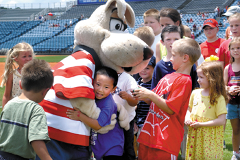 Champ receives a hug from Jingwei Song, 5, while being surrounded by other children after his introduction as the Vanderbilt Children's Hospital official mascot. 