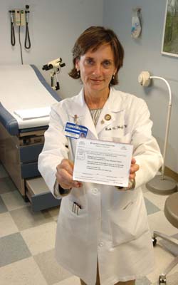 Beth Huff, M.S.N., R.N., with an emergency contraception prescription pad.
Photo by Anne Rayner