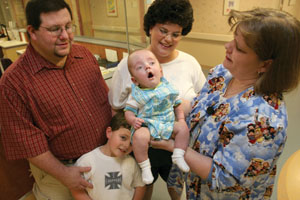 Communication, with patients and between staff members, is the cornerstone of Magnet Recognition efforts in the NICU. Here, Bonnie Parker, R.N., right, visits with 8-month-old Tanner Roberson and his family, parents Jimmy and Patty and brother Jay, when they returned to the unit for a social visit.
Photo by Kats Barry
