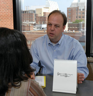 James Jackson demonstrates cognitive therapy techniques being studied for patients after leaving the ICU. (photo by Neil Brake)