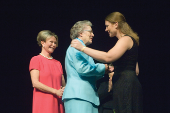 During Sunday's VUSN pinning ceremony, Dean Colleen Conway-Welch, Ph.D., left, looks on as Master of Science in Nursing graduate Candice Harvey, right, receives her professional pin from her grandmother Gene Harvey, who received her diploma in nursing in 1944 at Nashville General Hospital. 
Photo by Dana Johnson