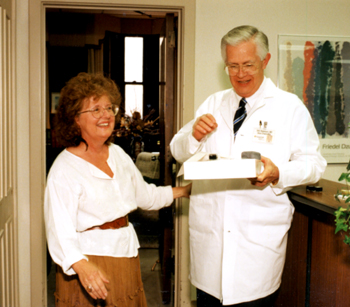 Dr. Robinson and his long-time executive assistant Jane Tugurian share a lighter moment. File photo