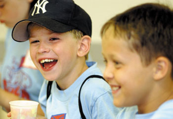 Jake Lampton, 8, left, and Brandon Ryckeley, 9, share a laugh during the 20th anniversary celebration.