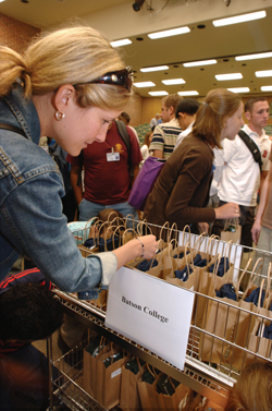Erin Fulchiero looks for her bag in the Batson College rack. (photo by Anne Rayner)