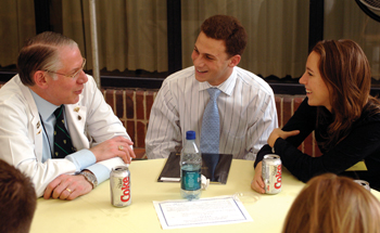 Dean Steven Gabbe, M.D., talks with first-year medical students Evan Silverton and Eve Henry during Monday’s luncheon with faculty advisers. 
Photo by Dana Johnson