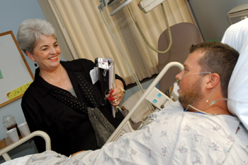 Gauld-Jaeger visits patient Scott Hollimon after surgery. The Office of Patient Affairs handles about 150 each month. Dana Johnson