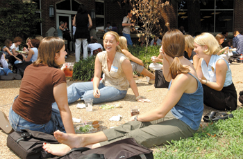 Diana Johnson, center, laughs with her new nursing school classmates, from left, Cathryn Sullivan, Brooke McClendon, and Courtney Elliot, during a lunch break from orientation activities at the School of Nursing Tuesday.