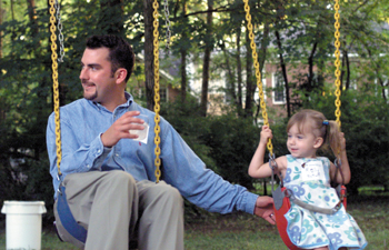 First-year medical student John Bottorff and his daughter Molly try out the swings in the back yard.