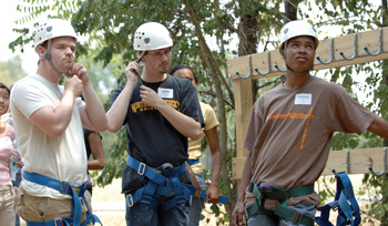 From left, Ryan Baldridge, Adam Ketron and Michael Irvin get ready for their turn on the zip line during orientation activities for incoming graduate students at the Joe C. Davis YMCA outdoor center. (photo by Neil Brake)