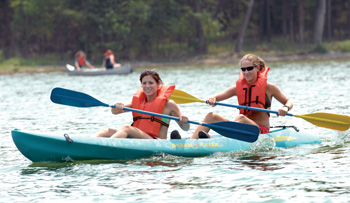 Jessi Mazerik, left, and Mallory Hacker synchronize their efforts at Percy Priest Lake. (photo by Neil Brake)