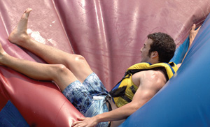 Dario Gutierrez takes a bounce on the inflatable at the outdoor center. (photo by Neil Brake)