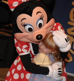 Heather Anderson, 7, gets a hug from Minnie Mouse. (photo by Dana Johnson)