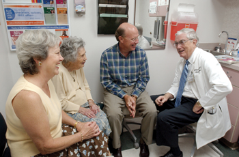 Anderson Spickard Jr., M.D., visits with longtime patients from left,  Ann Rose Richards, her mother Sue Baird, and her husband Joe. Sue, 95, of Franklin, Ky., and her family have been patients of Spickard Jr. for the past 40 years. They came to Vanderbilt to say goodbye to him. Photo by Dana Johnson